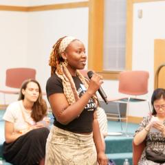 Program intern Lanre speaking at the June 2024 Dialogue Nights