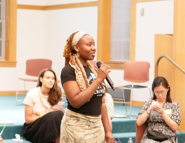 Program intern Lanre speaking at the June 2024 Dialogue Nights